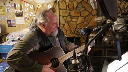 Folk Singer Picking Acoustic Guitar